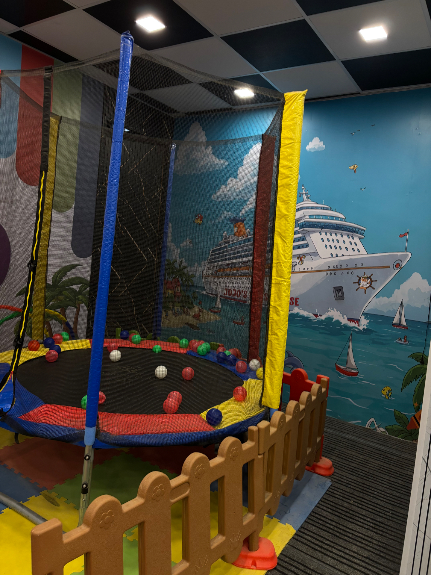 Trampoline with ball pit and cruise mural